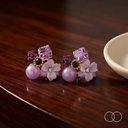 The pair on a polished walnut table beside a plain ceramic dish