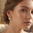 The Bow and Pearl stud worn, showing the scale of the bow and pearl against the ear