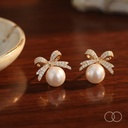 The pair on a polished walnut table beside a gold rimmed ceramic dish