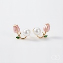 Close up of the pair on a plain pale ground, showing the tulip, the stem, the green leaf and the pearl back