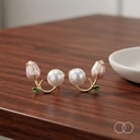 The pair on a polished walnut table beside a plain ceramic dish