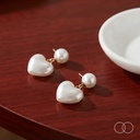The pair on a polished walnut table beside a plain ceramic dish