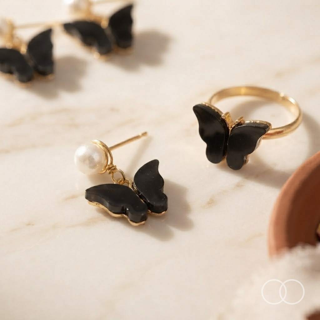 Close up of the black butterfly earring and the matching gold ring