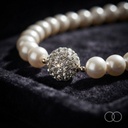Close up of the crystal ball accent set between the pearls
