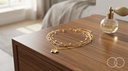 The Blossom Layered set on a wooden dresser beside a perfume bottle