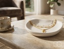 The Blossom Layered set resting in a ceramic dish on a stone table