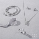 The Solitaire Silver trio arranged on linen with a ribbon