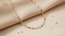 The Rainbow Bead necklace draped over cream silk