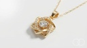 Close up of the interwoven gold star pendant and its central stone