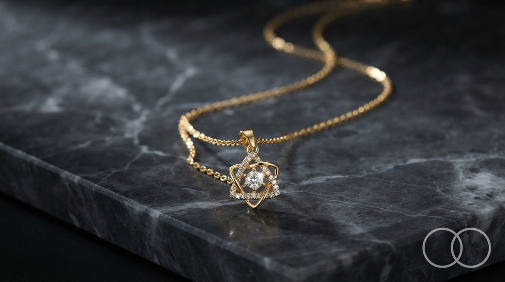 The Six-Point pendant and chain on a black marble slab