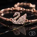 Rose-gold_swan_bracelet_on_marble_202608212040.webp