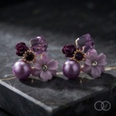The pair on a dark marble slab, showing the amethyst cube, carved rose and shell flower